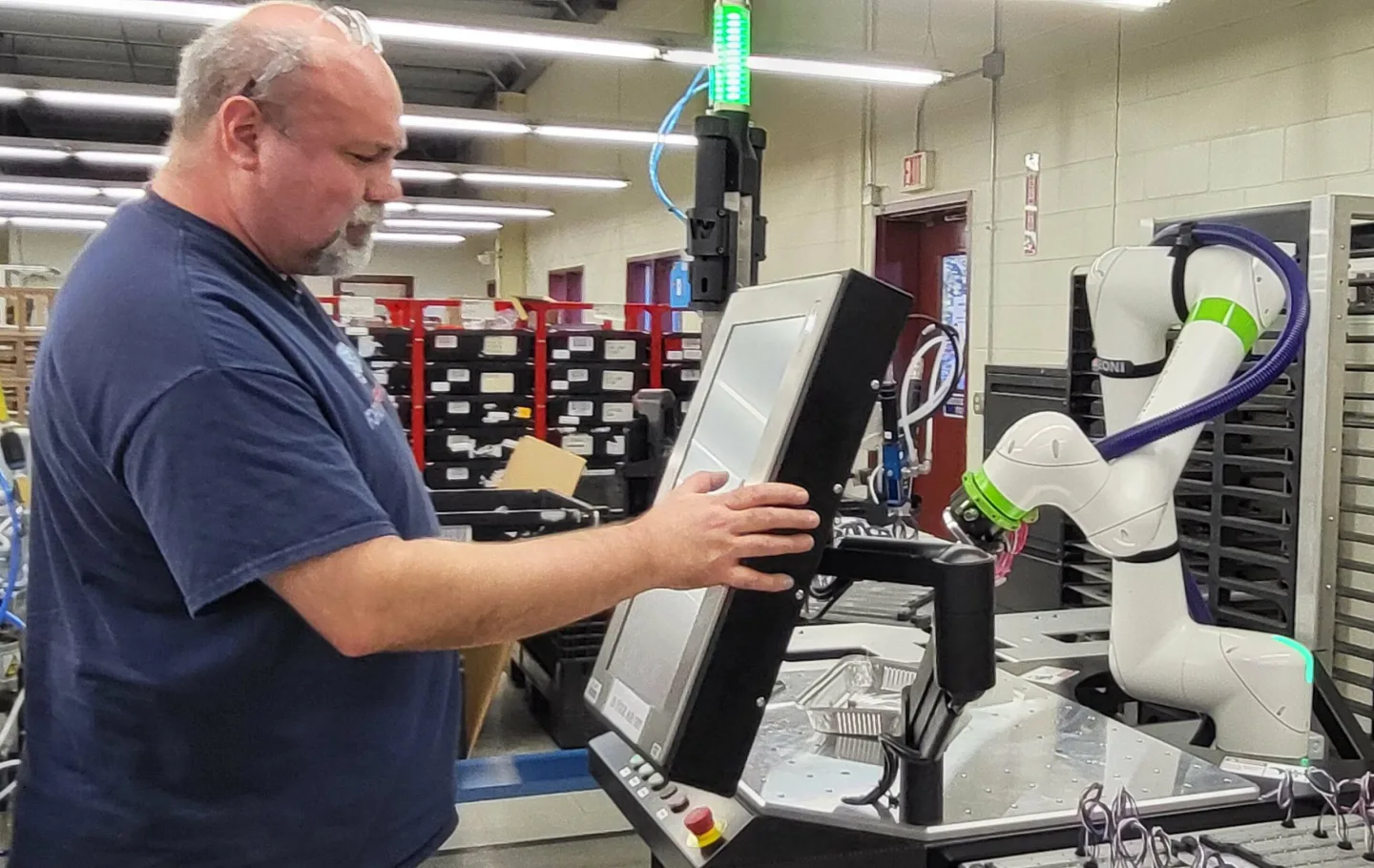 Whelen engineer operating machine in a Whelen manufacturing facility