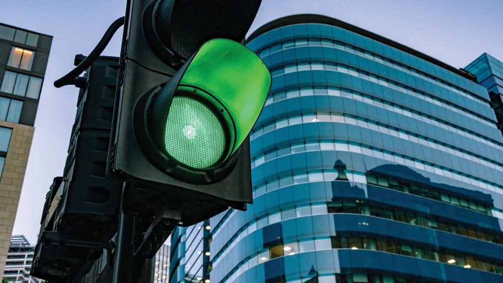 image of green traffic signal in an urban setting