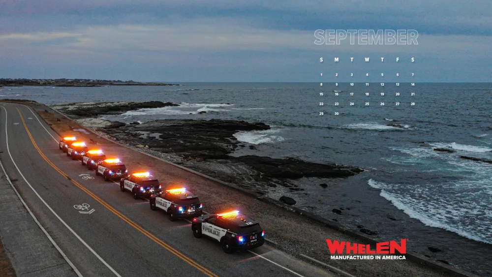 downloadable wallpaper calendar of row of police emergency vehicles parked along coastline view
