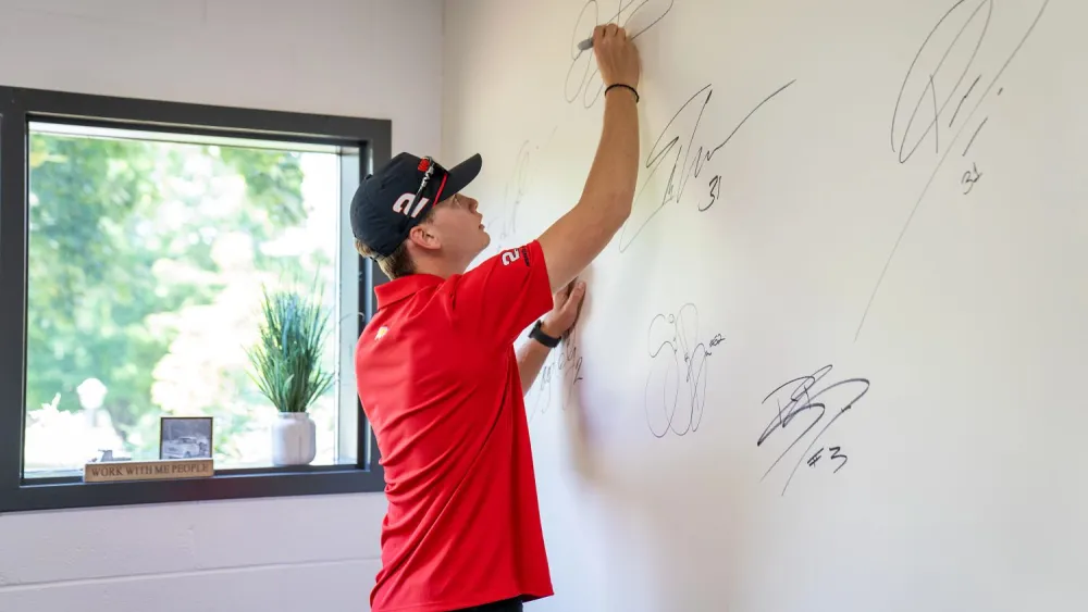 Jesse Love adds his signature alongside those of past Whelen drivers.