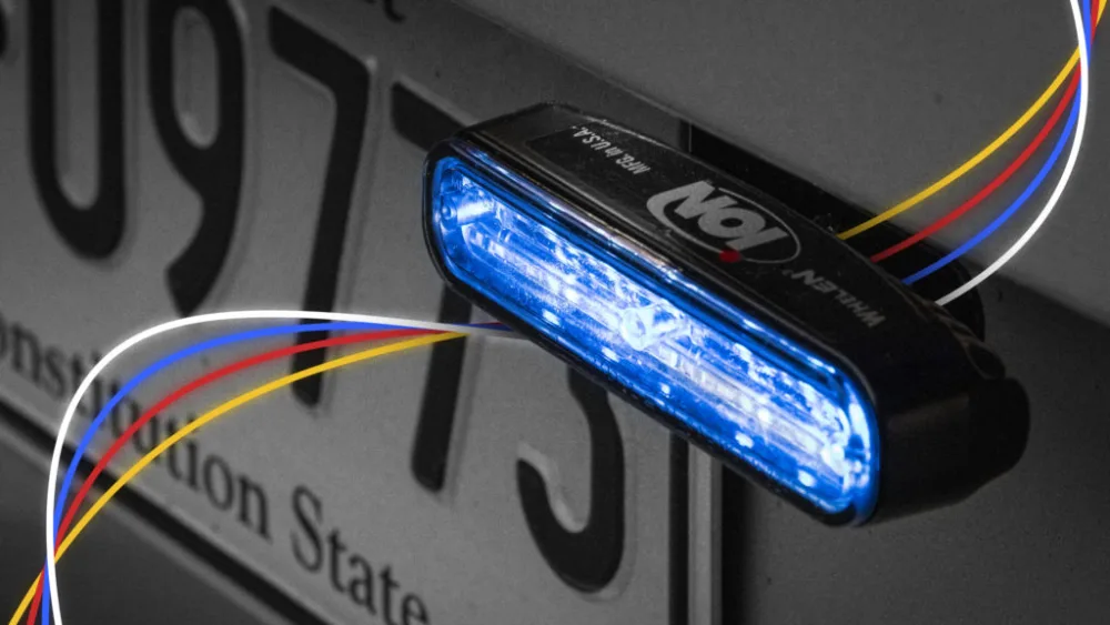 image of blue Whelen ION Series lighthead installed above license plate of police emergency vehicle