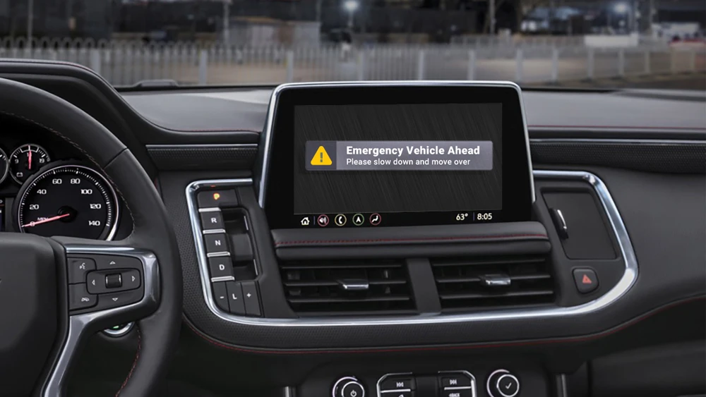 image of digital alert on screen console inside emergency vehicle with warning reading "Emergency Vehicle Ahead: Please slow down and move over"