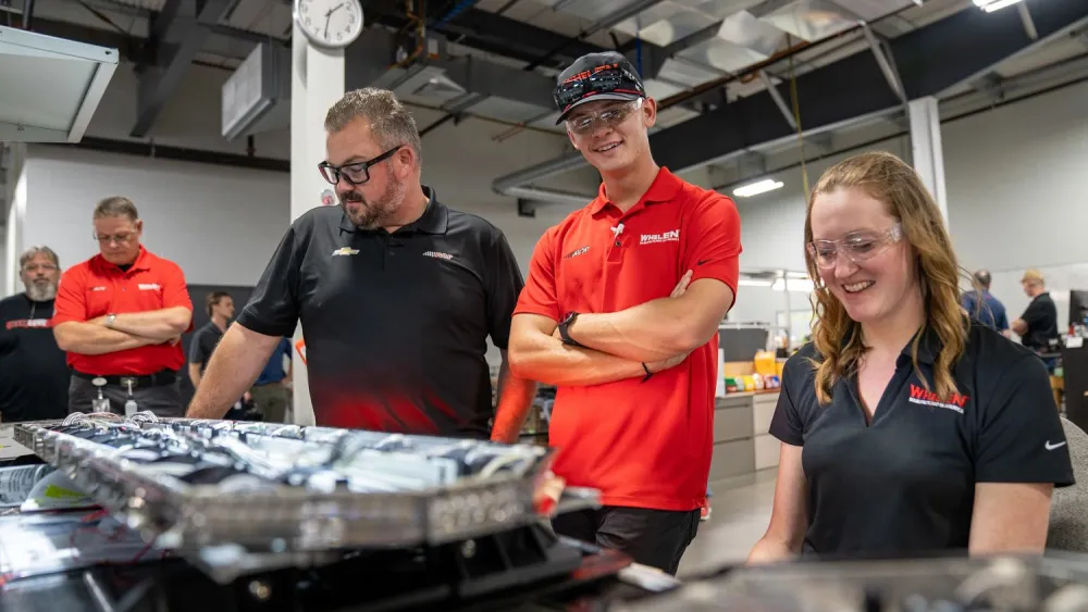Jesse Love and Danny Stockman learn the ropes from Janel Palmieri in lightbar production.