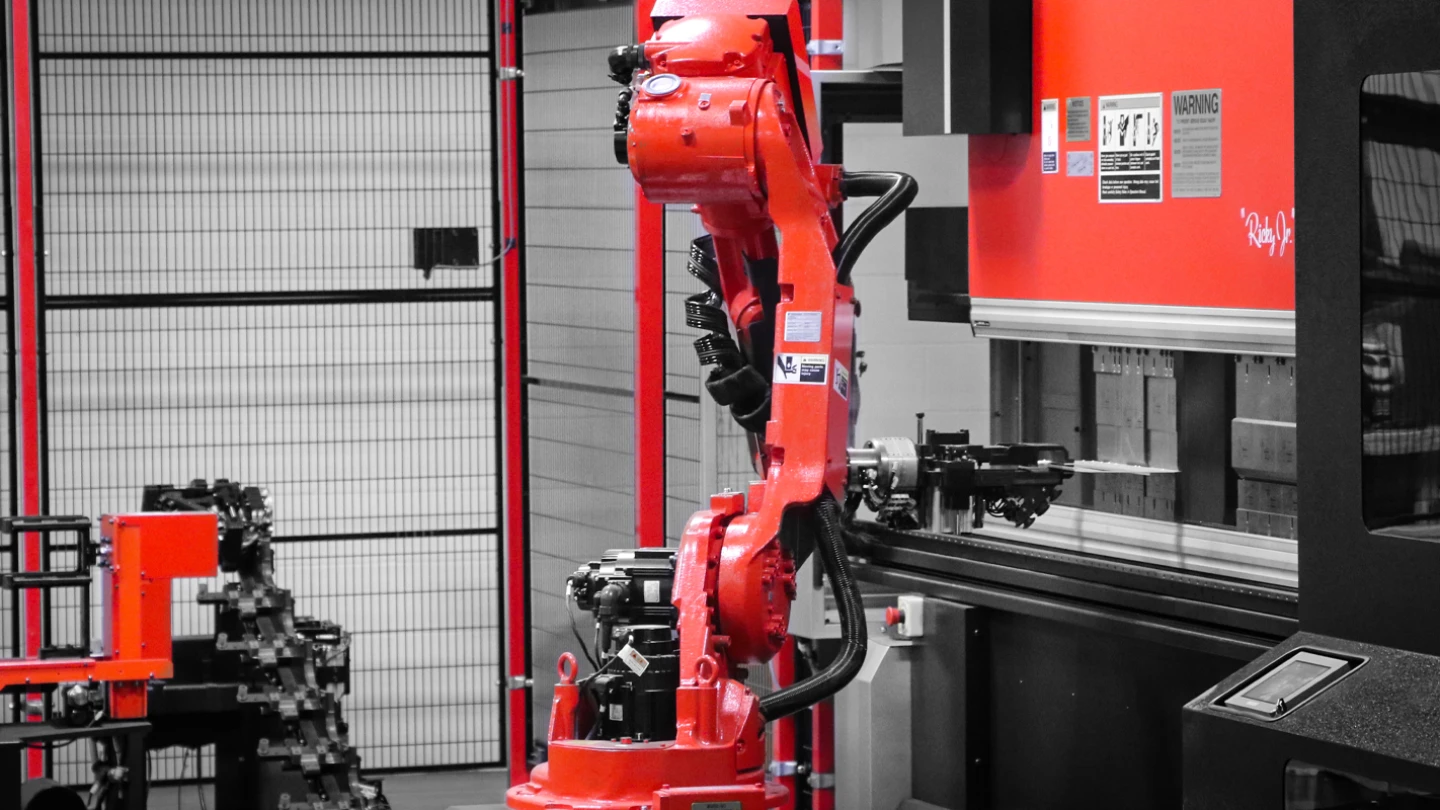image of robotic arm in use at Whelen Engineering manufacturing facility for emergency lighting
