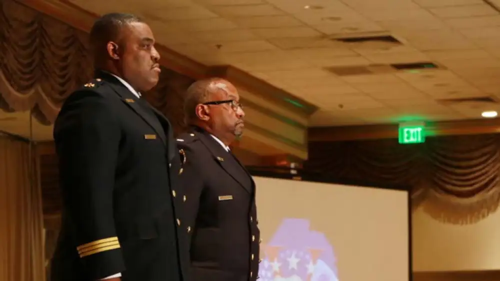 image of two law enforcement officers standing to attention during a presentation