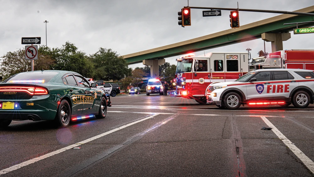 image of fire and police emergency vehicles assembled at road intersection