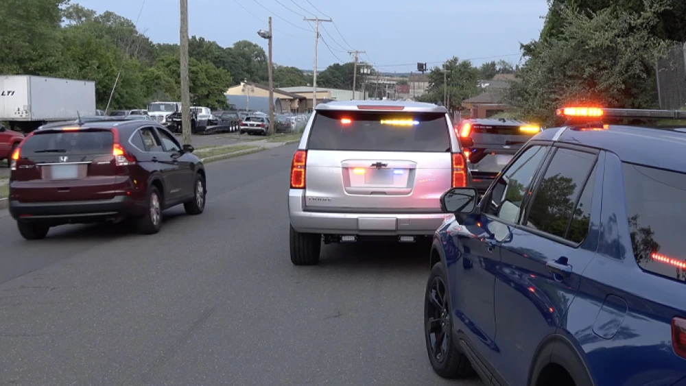 image of emergency vehicles with flashing lights on roadway with other traffic