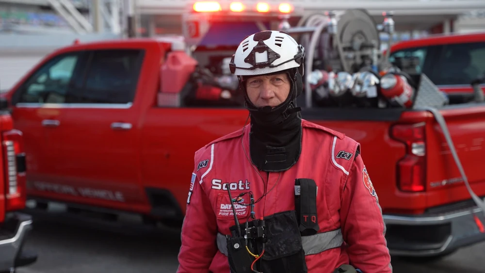 image of NASCAR fire rescue professional standing in front of fire emergency vehicle
