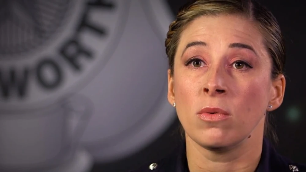 image of female law enforcement officer speaking to camera