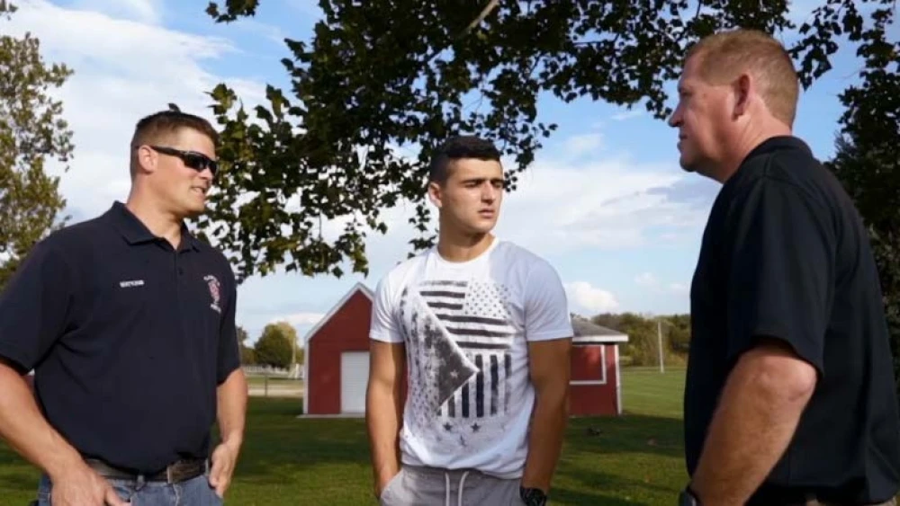 image of group of law enforcement officers in conversation in a rural setting