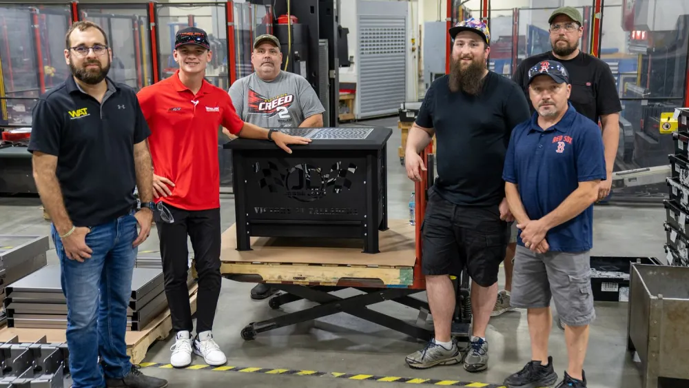 Jonathan Gibbs and the team proudly display Jesse’s custom Whelen Firepit.