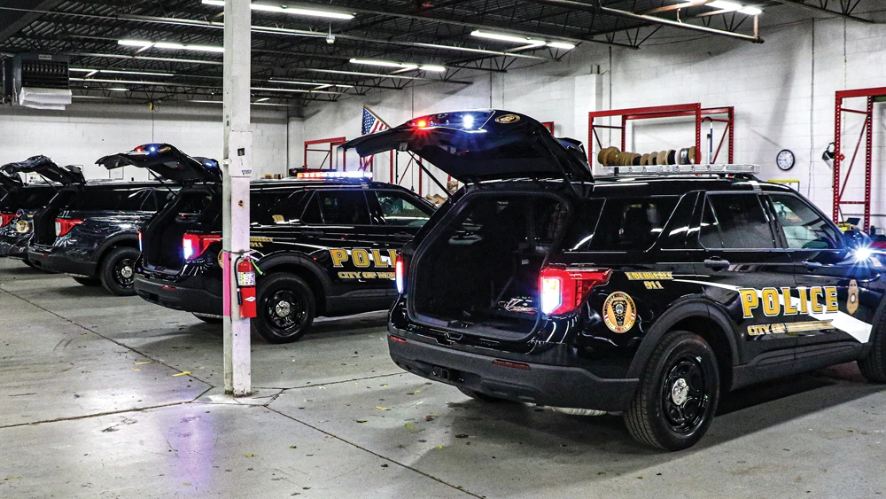 image of police vehicles with trunks opened inside a parking garage